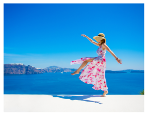 happy woman pretty dress and hat jumping in the air