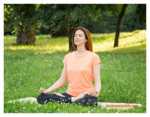 woman meditating in field